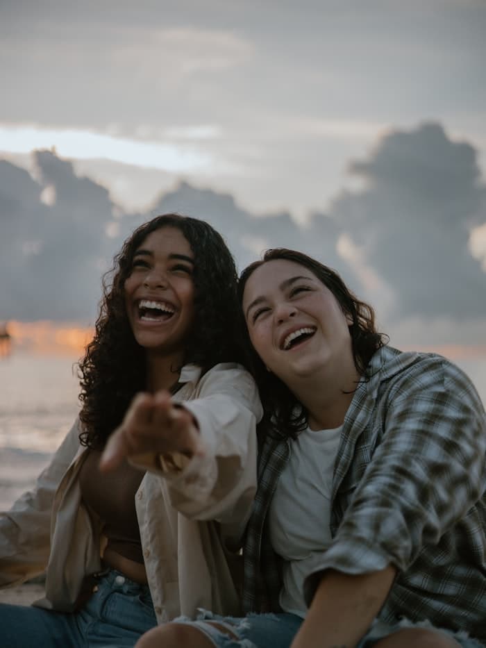Two friends laughing at the beach